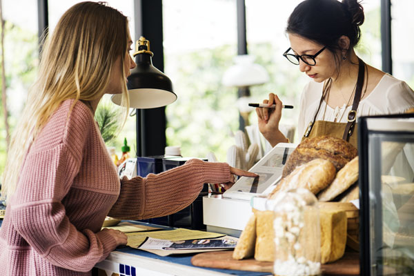 Customer ordering pastry at counter