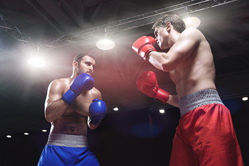 Boxers fighting in boxing ring